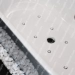 White Bathtub Pebbles Black Background Image & Google Slides Theme