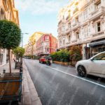 White Cars Red Buildings Green Trees Urban Street Background Image & Google Slides Theme