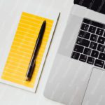 Yellow Lined Notepad Black Pen Silver Laptop Background Image & Google Slides Theme